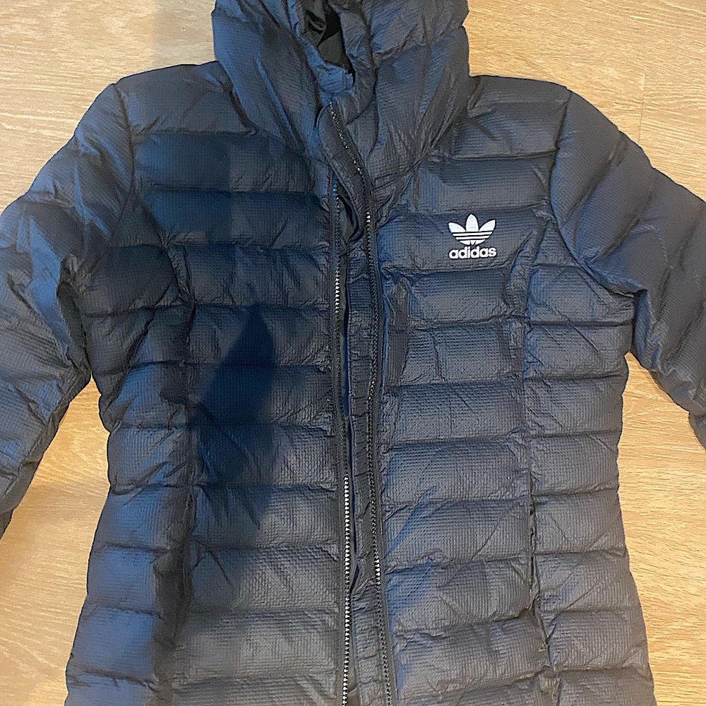 Adidas Small puffy jacket. It is light and keeps you warm. Wore it few times.